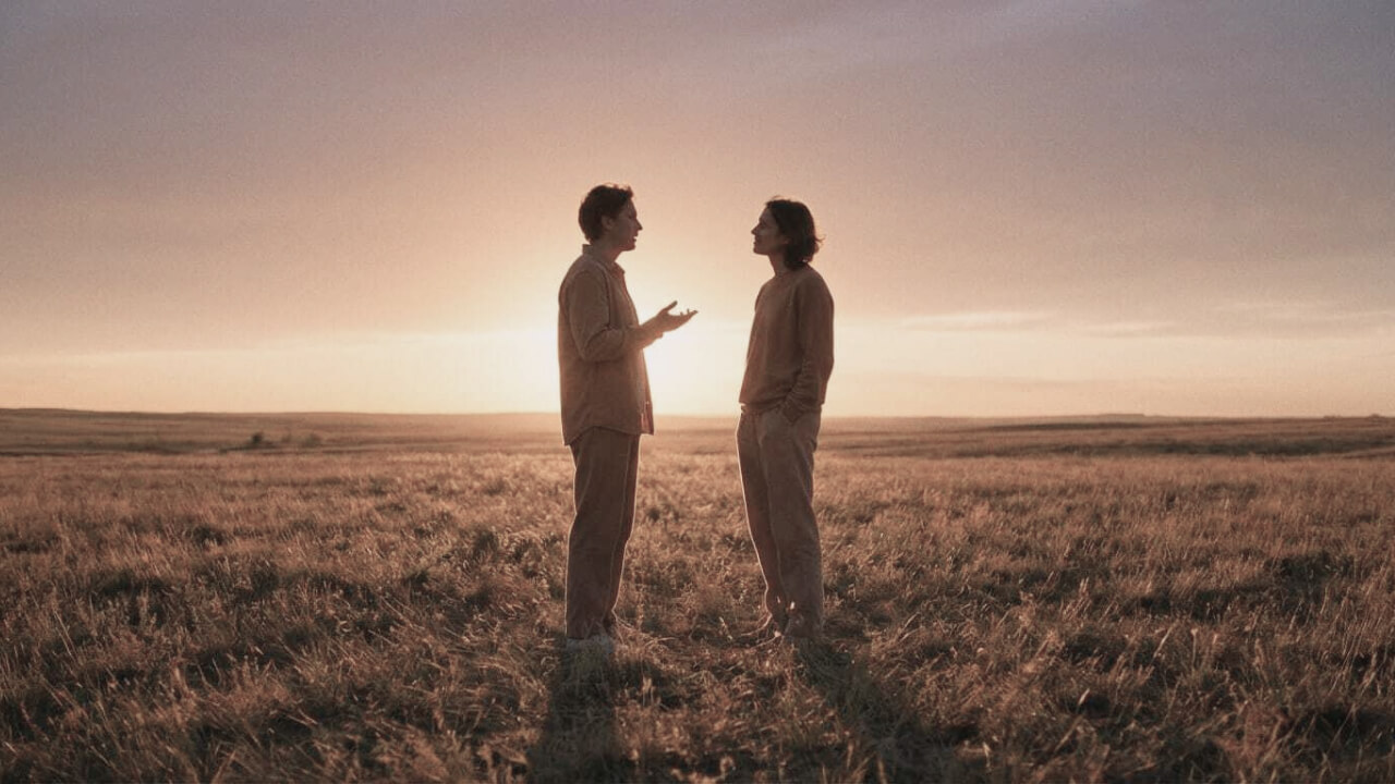 Two people in open conversation at sunset — holding strong views with open hands