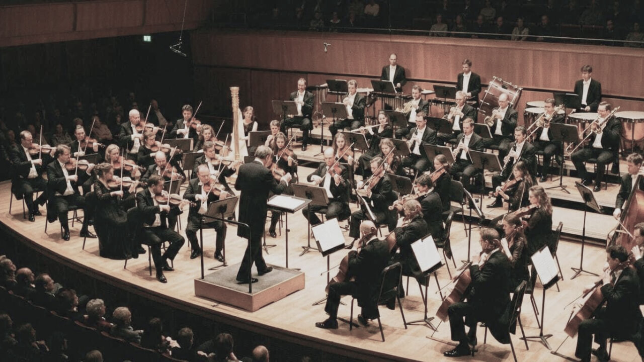 Orchestra performing together — belonging to the whole